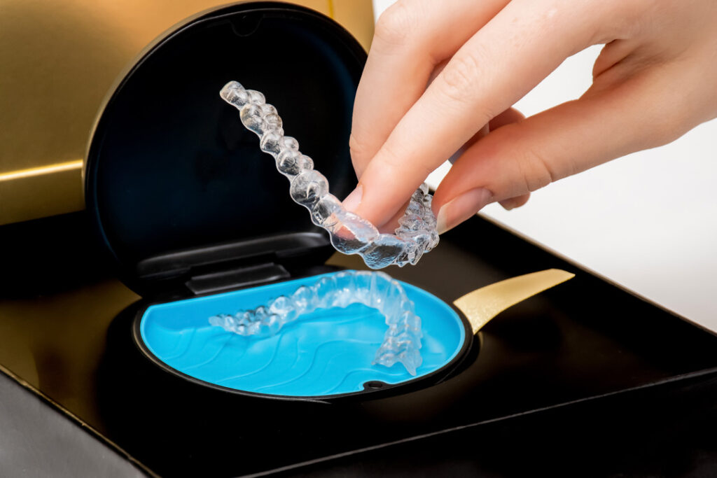 Transparent teeth aligners in a box