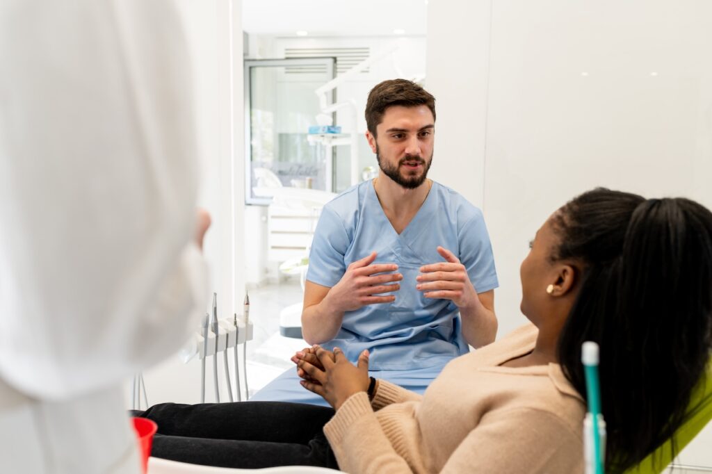 dentist and patient discussing wisdom teeth removal process